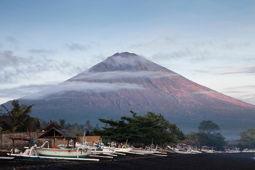 Bali's highest volcano Mt Agung, seen from the black sand beach at Amed village in East Bali, Indonesia.